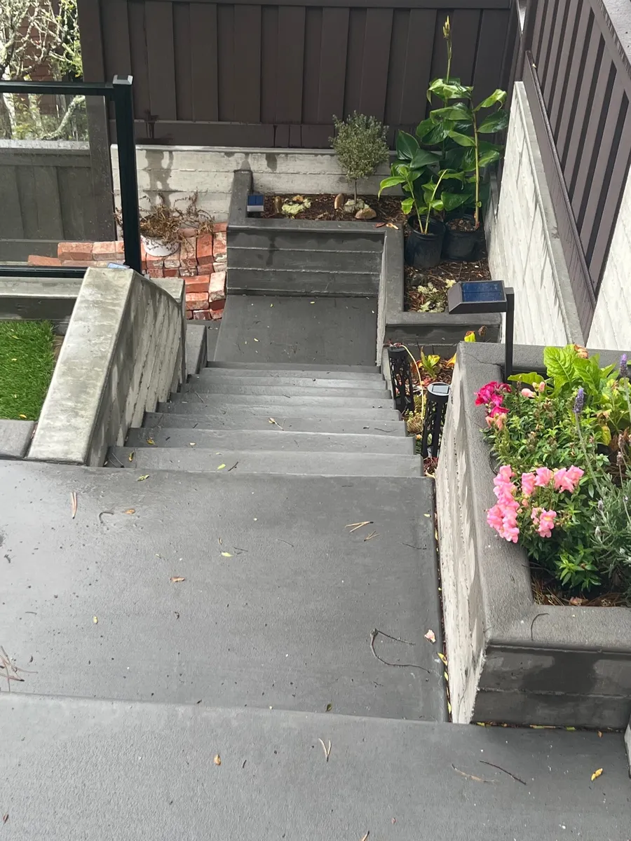 Concrete steps and a walkway between low walls
