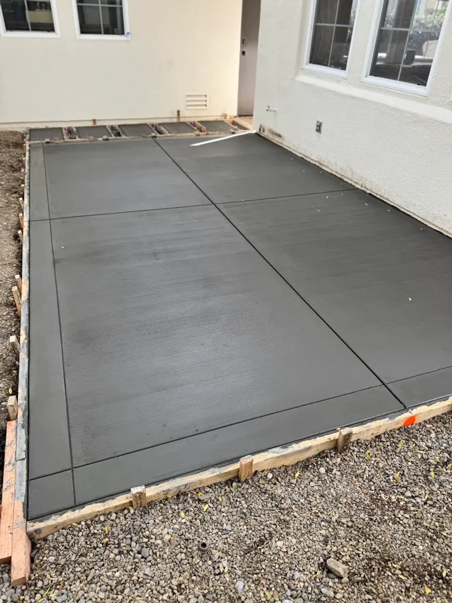 Fresh concrete patio divided by straight joints