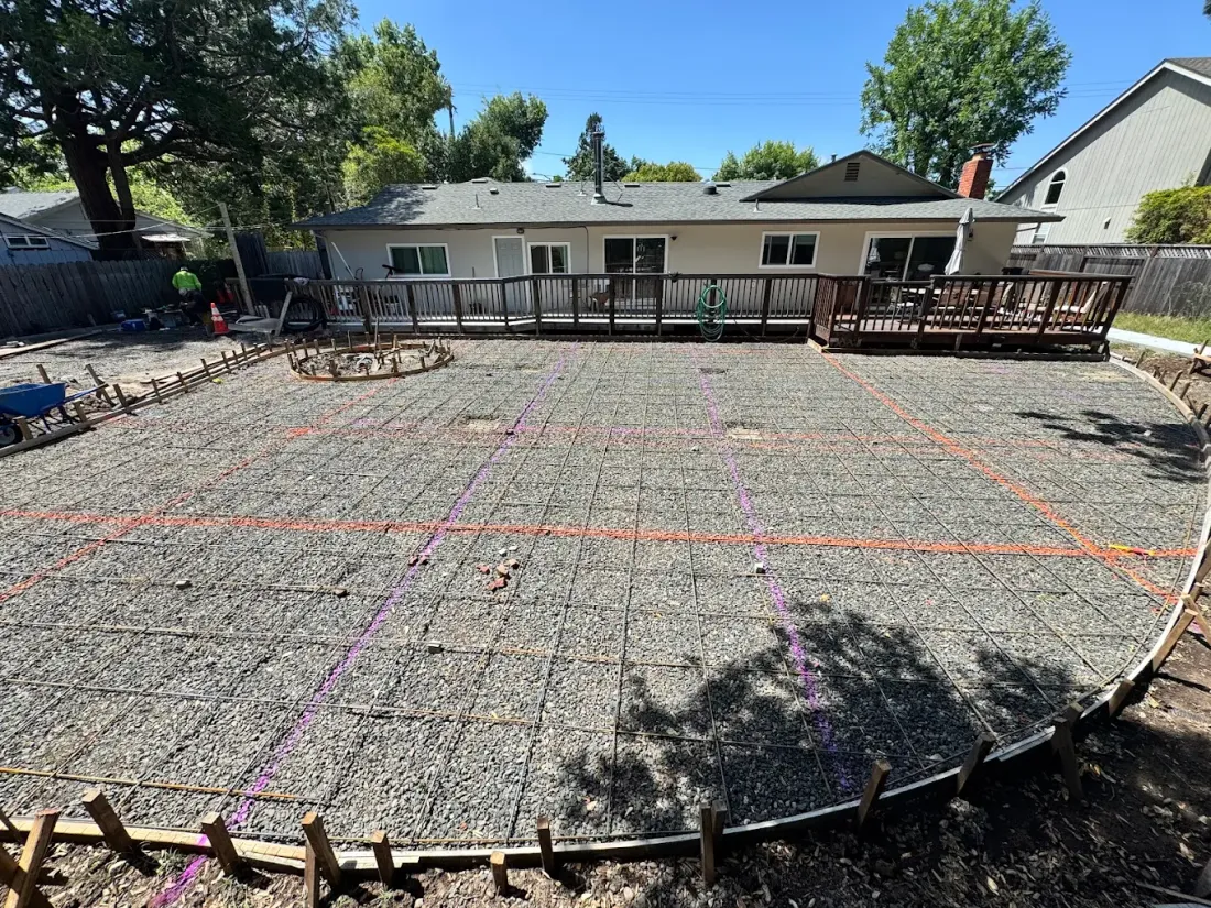 Broad backyard slab area prepared with steel reinforcement
