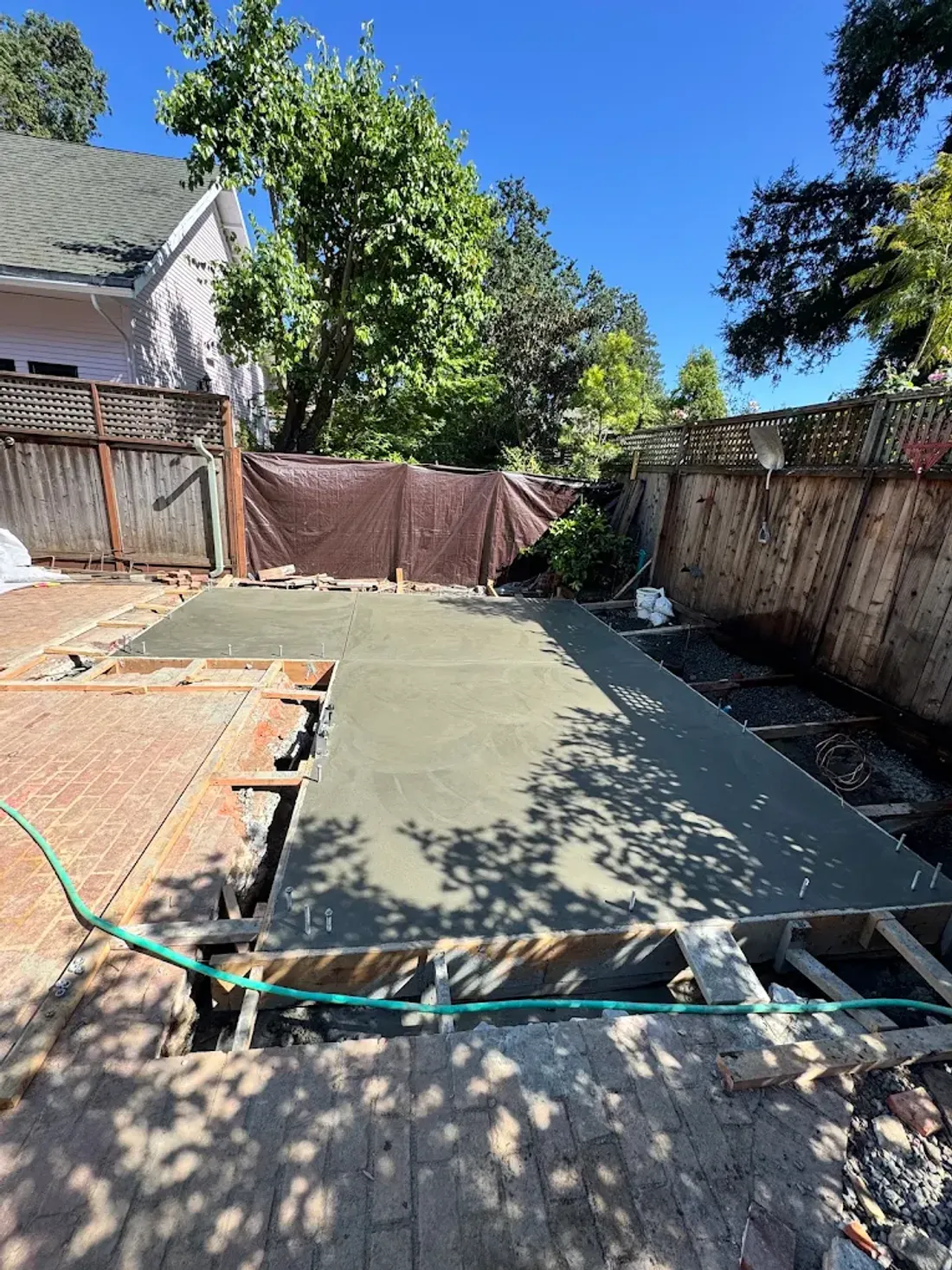 Fresh concrete placed inside curved backyard forms