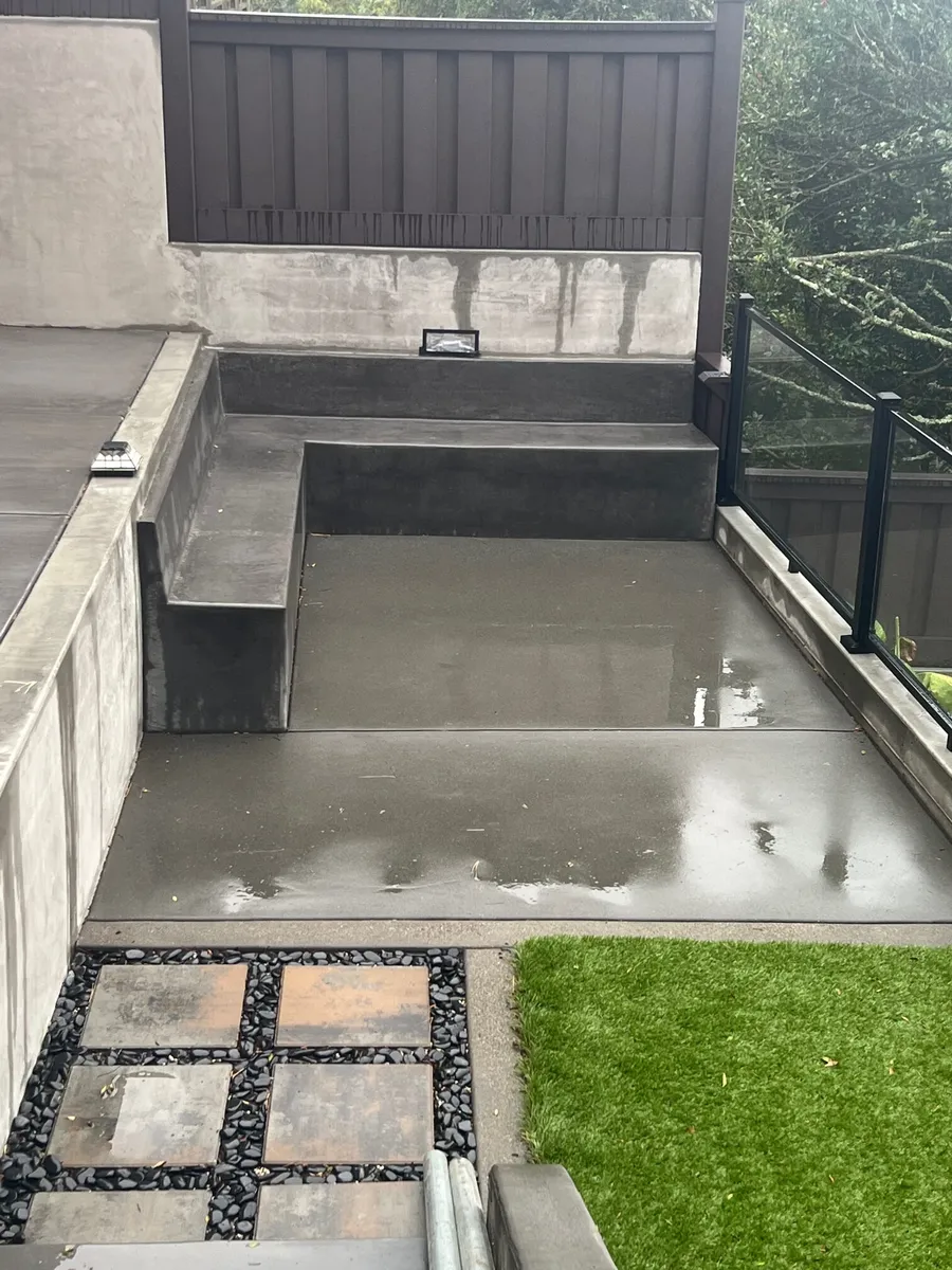 Concrete landing and steps beside a handrail