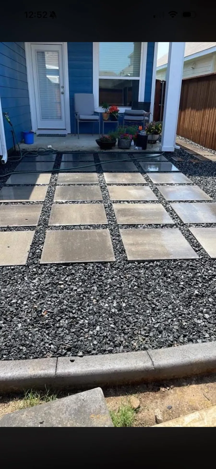 Square concrete walking pads set in dark gravel