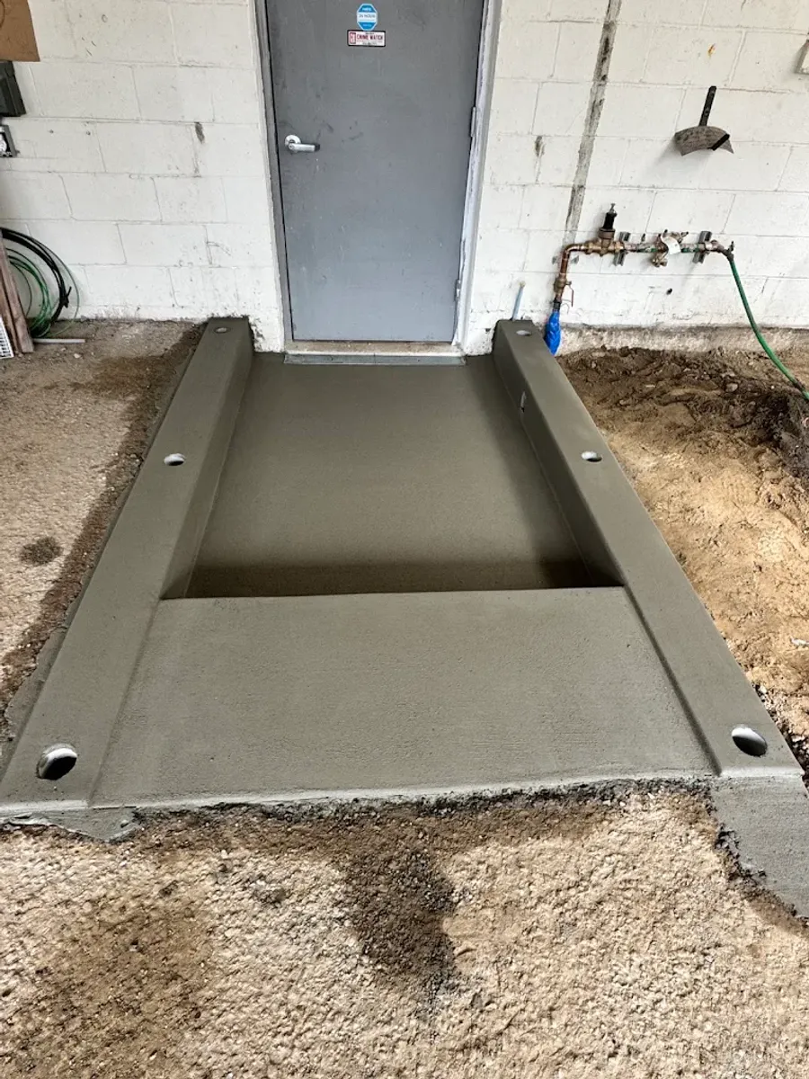 Fresh concrete landing outside a rear doorway